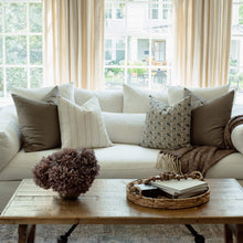 Mabel navy floral pillow with ivory striped pillows on a sectional