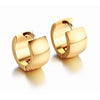 Jax Huggies mini gold hoop earrings on neutral background