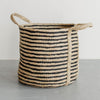 Round jute laundry hamper styled in a modern home setting