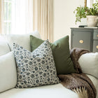 Celine navy blue vintage floral throw pillow cover on a sofa