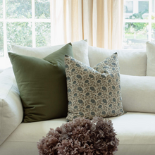Mabel navy floral pillow with ivory ditsy and olive pillows on a neutral sofa