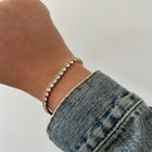 Close-up of Rhae Tennis Bracelet gold-plated links and stones