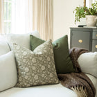 Esme sage and taupe botanical throw pillow cover on a sofa