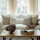 Faye striped pillow with sage and ivory pillows on a neutral sectional