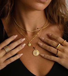 Model wearing Shiloh Band Ring stacked with dainty gold rings