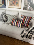Cecilia black and white striped cotton throw blanket draped over a sofa