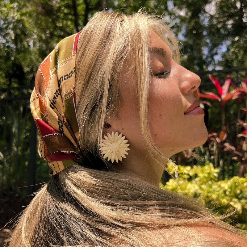 Close-up of gold Sol Statement Earring with bold design