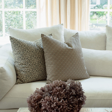 Adeline blue floral pillow styled with neutral striped pillows