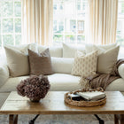 Odette terracotta botanical pillow styled on a sectional