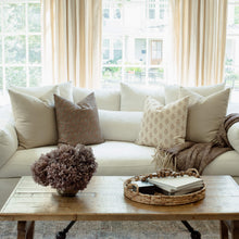 Odette terracotta botanical pillow styled on a sectional