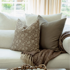 Clara taupe floral pillow on a neutral sectional