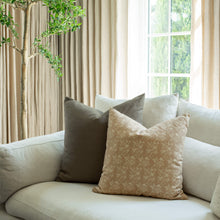 Fleur tan floral throw pillow styled on an organic modern sofa