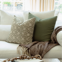Esme sage green pillow with taupe floral pillows on a neutral sectional