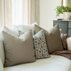 Henley set with taupe and navy floral pillows on a sofa
