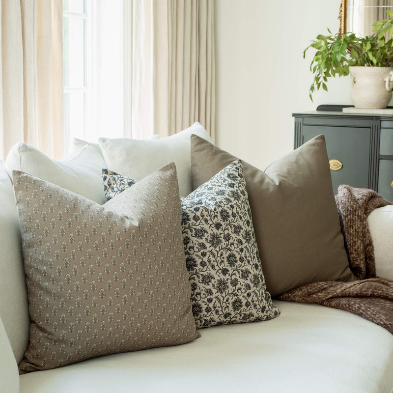 Henley set with taupe and navy floral pillows on a sofa