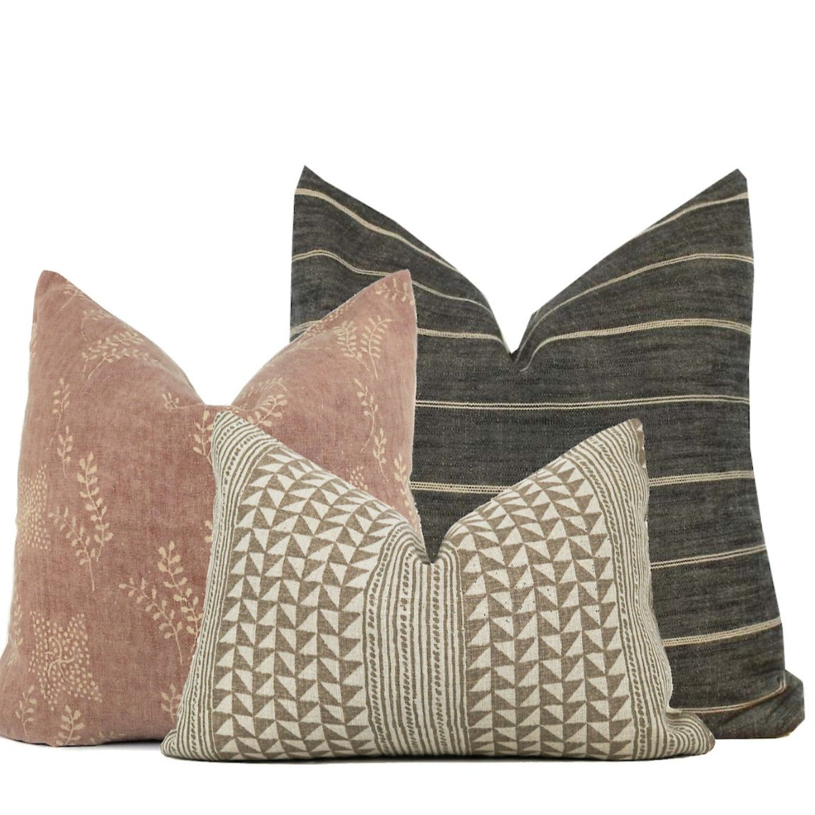 Pillow Cover set of 3 featuring a dark grey stripe pillow cover in 22"x22", a 20"x20" Blush/rust colors pillow cover with soft floral detail, and a 14x20 Aegean Stripe Pillow Cover with a beige and cream geometric design. 