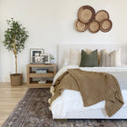 a bed with a bunch of pillows on it