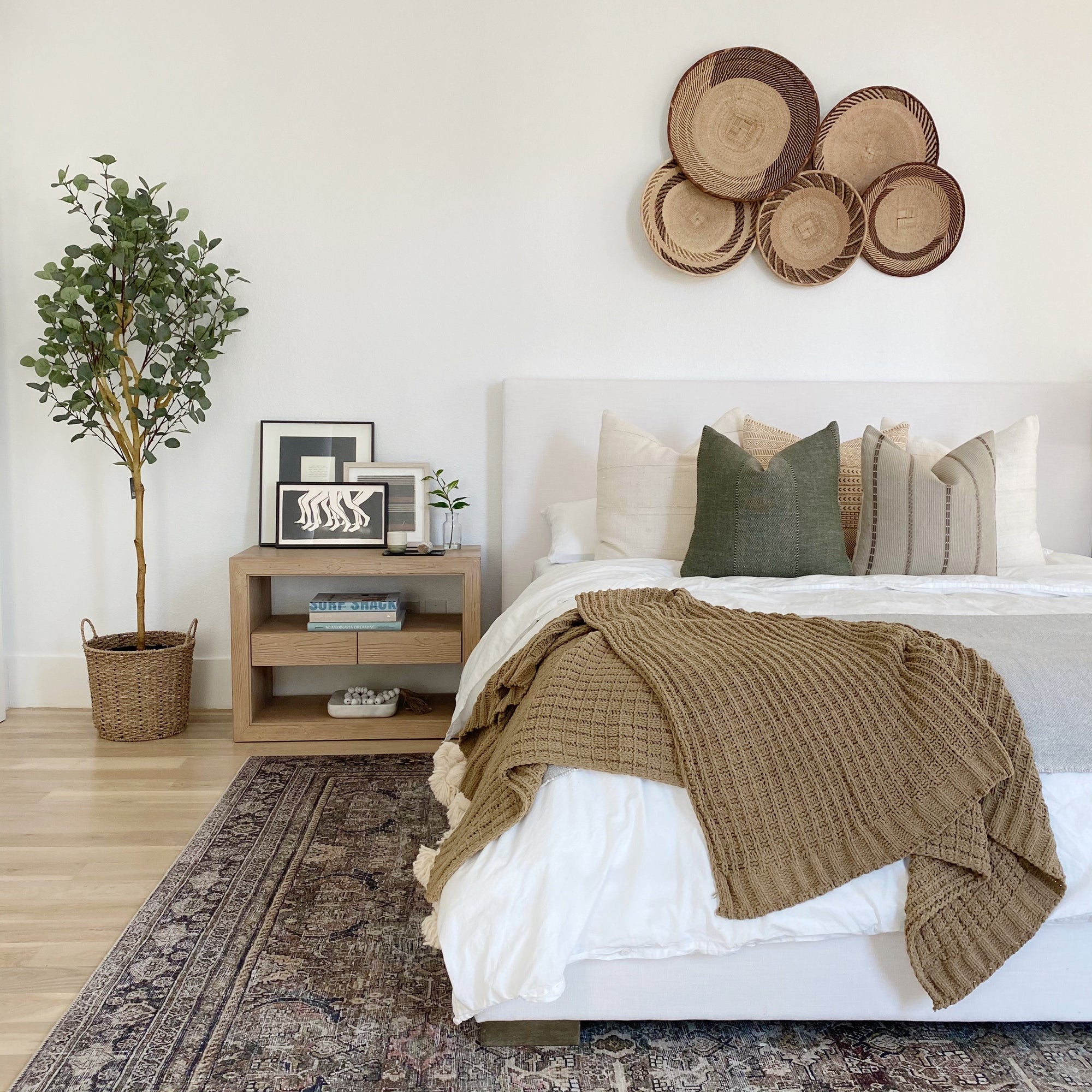 a bed with a bunch of pillows on it