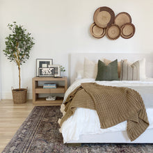 a bed with a bunch of pillows on it