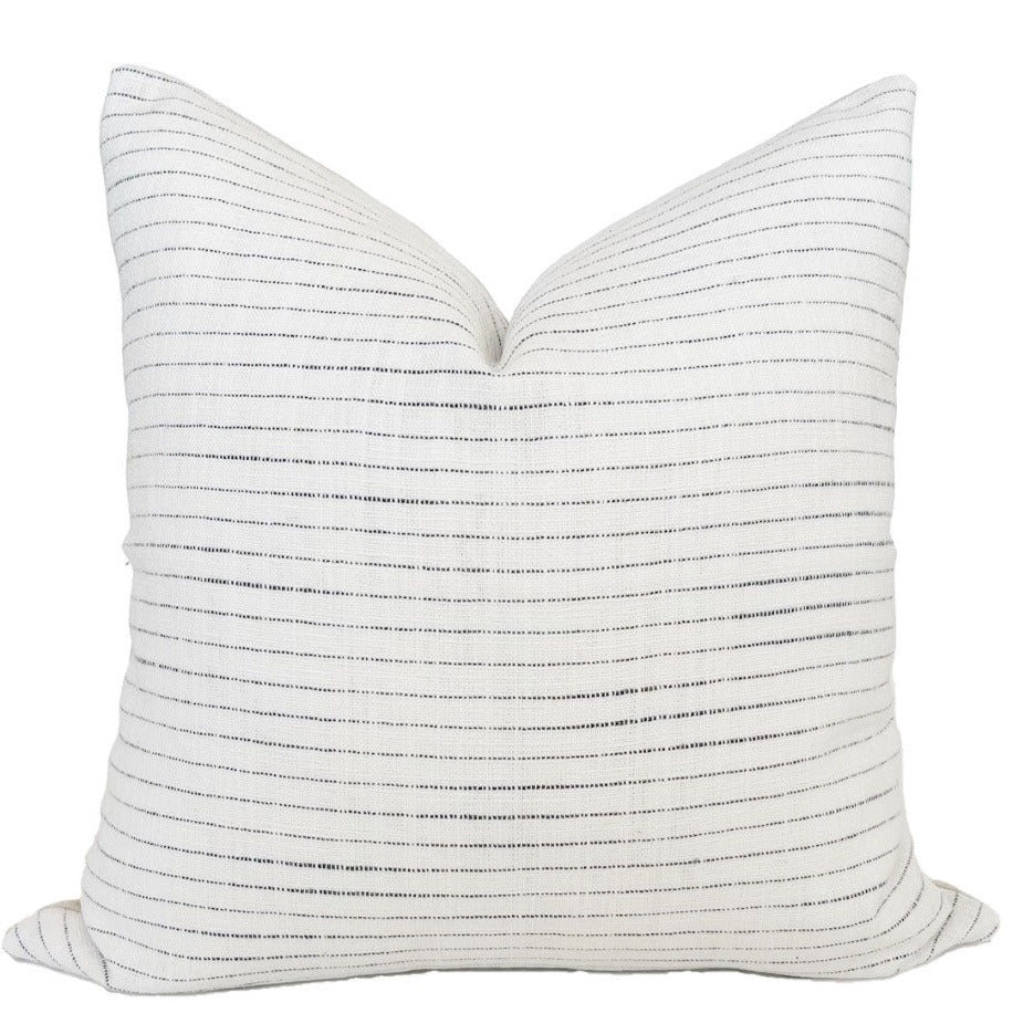 White coastal pillow cover with thin woven blue stripes. 