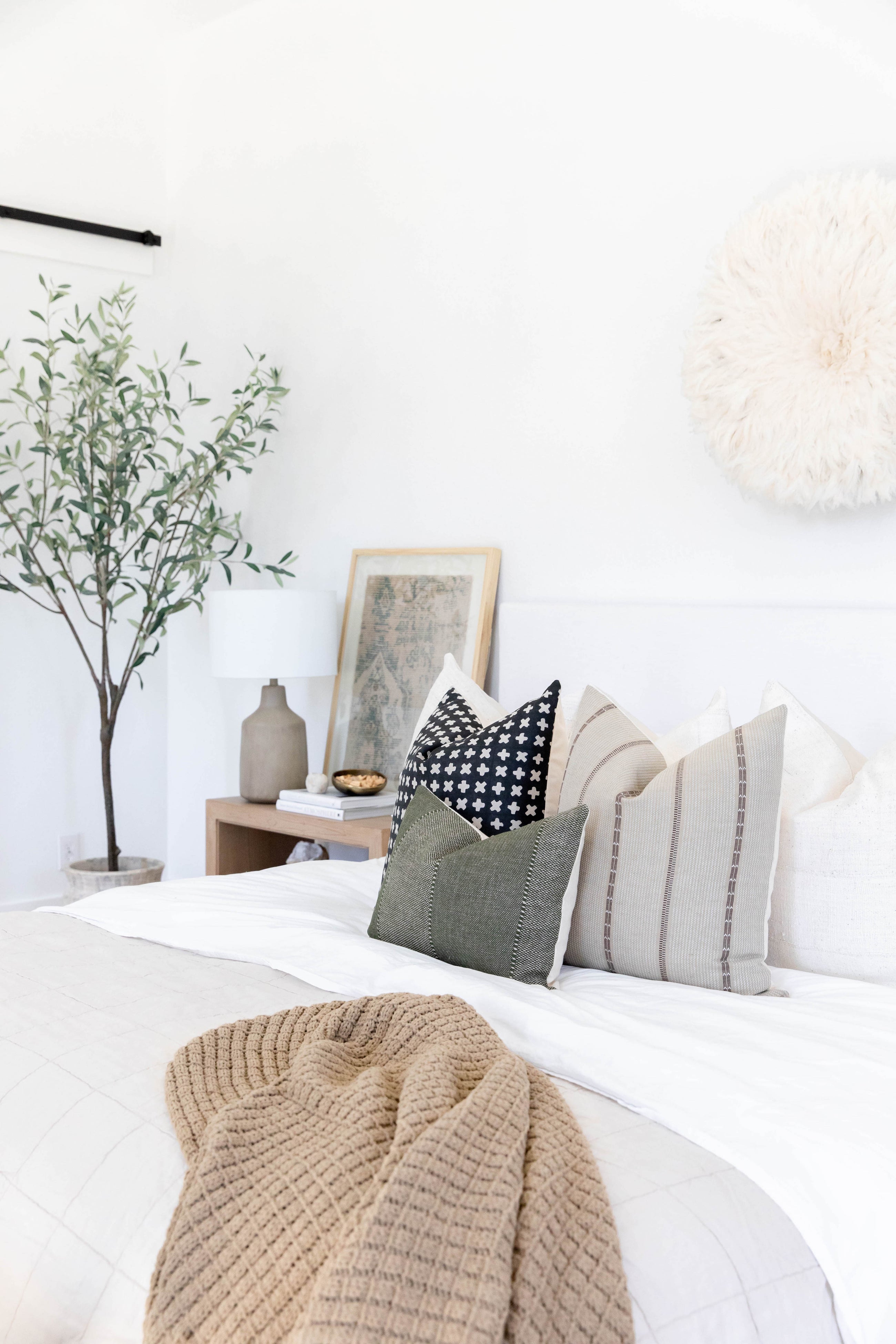 a bunch of pillows on the bed