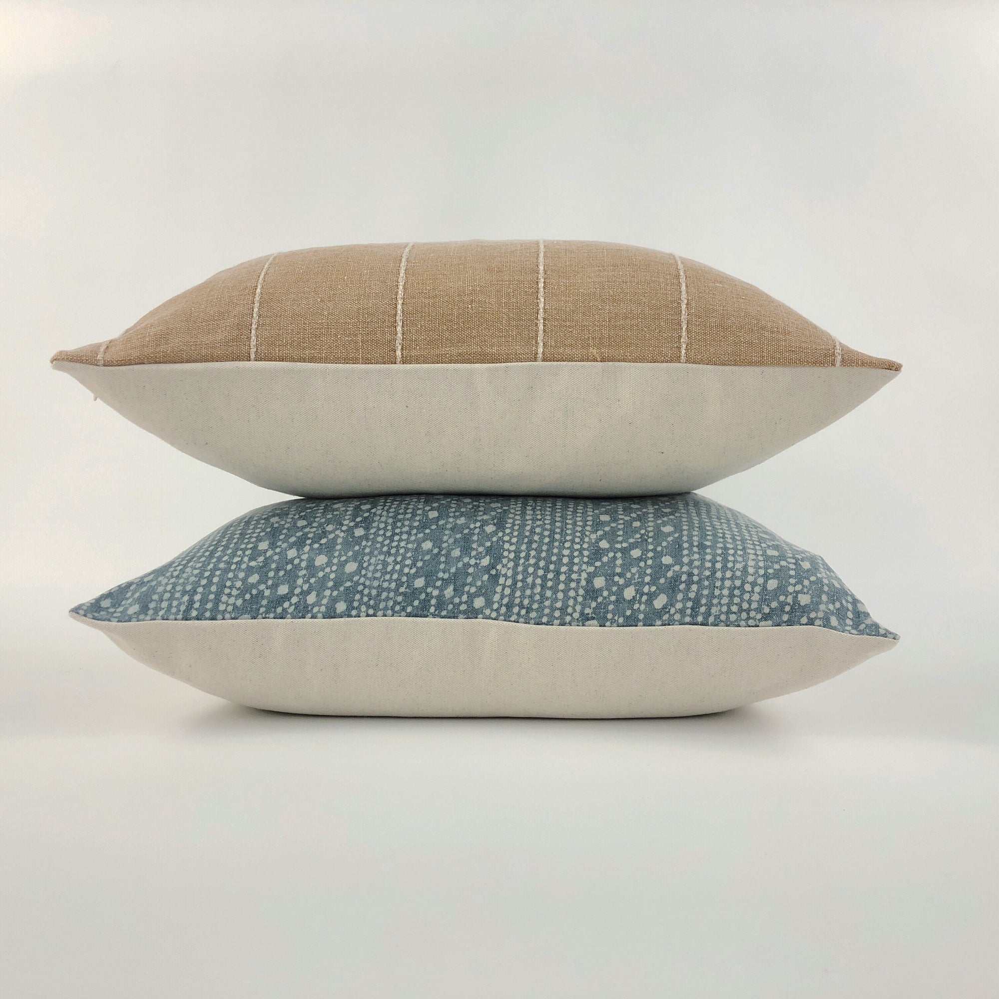 Small stack of throw pillows on a white background
