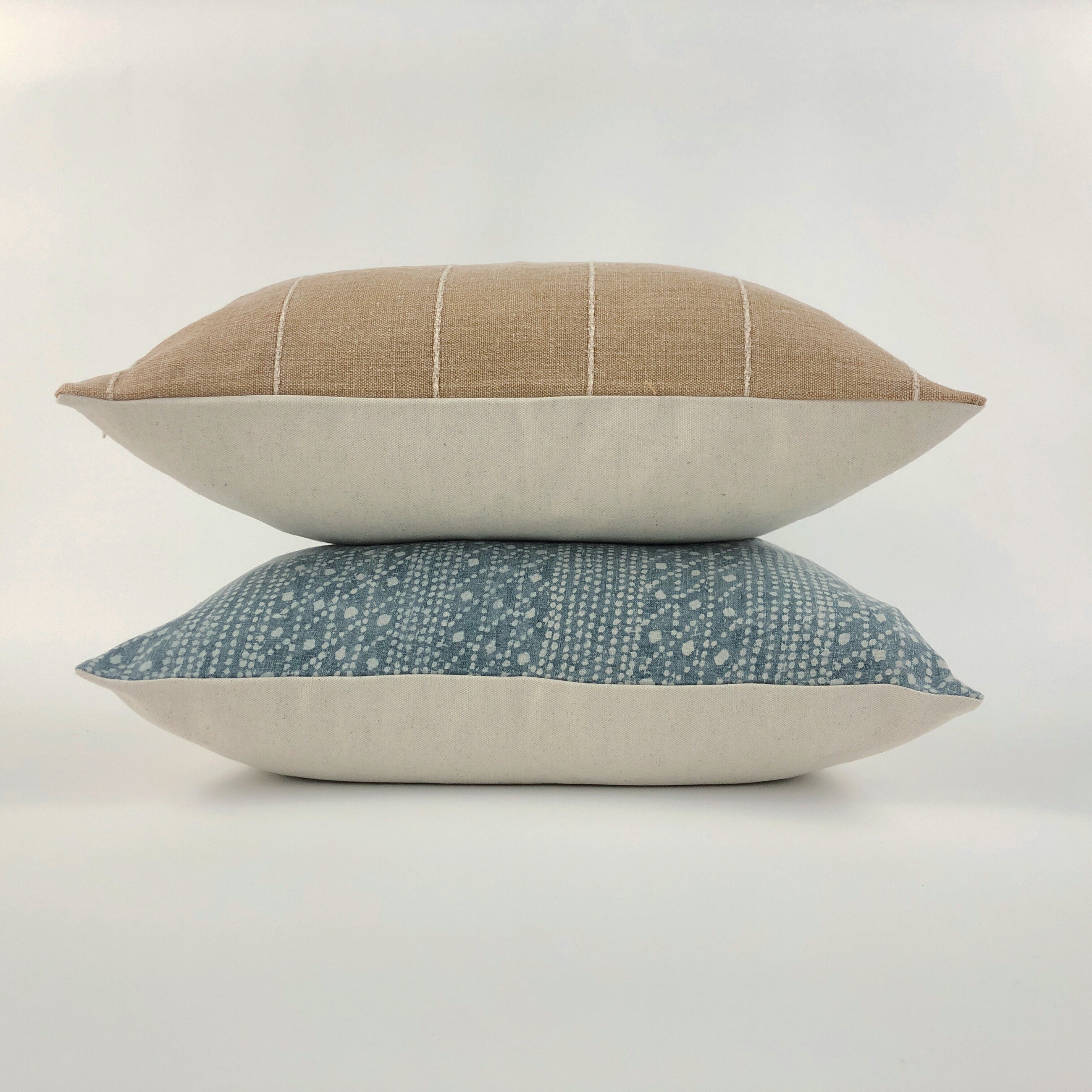 Small stack of throw pillows on a white background