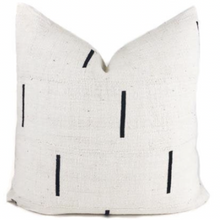 a mudcloth pillow that is black and white