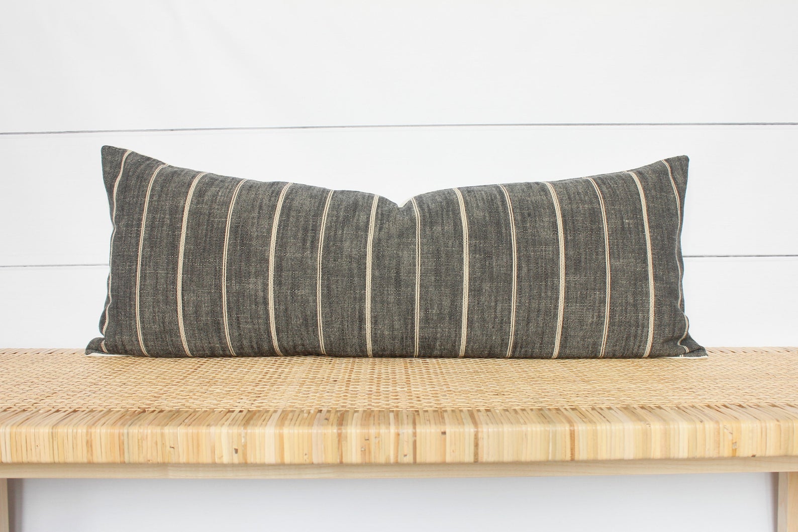 Dark Grey Stripe Pillow Cover on a wooden bench