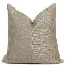 a tan pillow with a white backround
