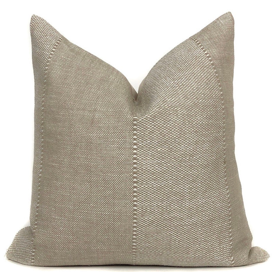 a tan pillow with a white backround