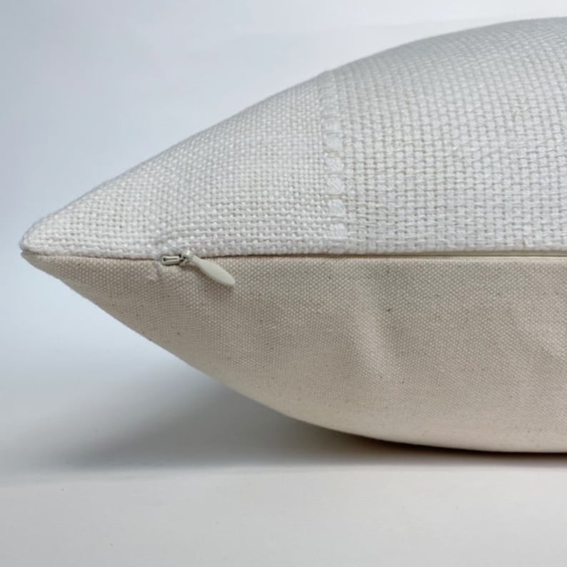 a zipper on a white pillow