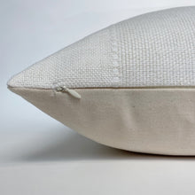 a zipper side of a white pillow
