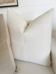 a white pillow on a couch