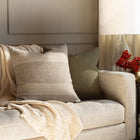 Stefanie Stripe Pillow Cover resting on a sofa